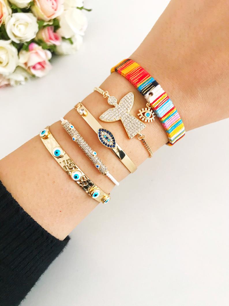 Gold Evil Eye Bracelet Set featuring adjustable bangles with unique designs, handmade from tarnish-resistant stainless steel.