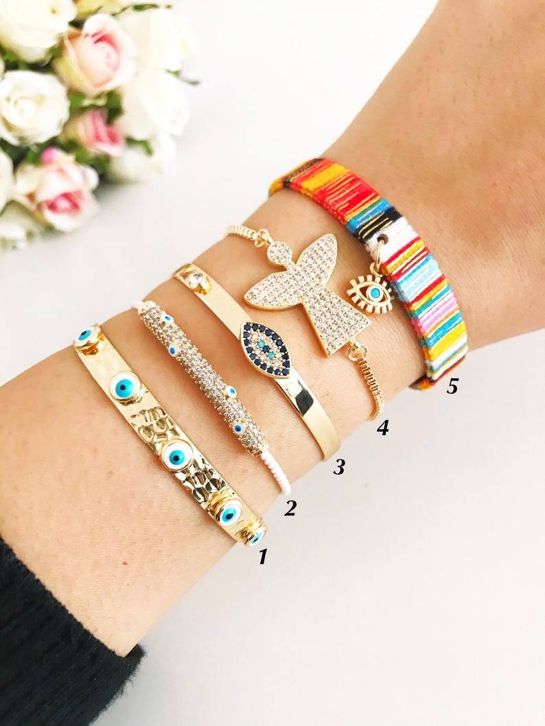 Gold Evil Eye Bracelet Set featuring adjustable bangles with unique designs, handmade from tarnish-resistant stainless steel.