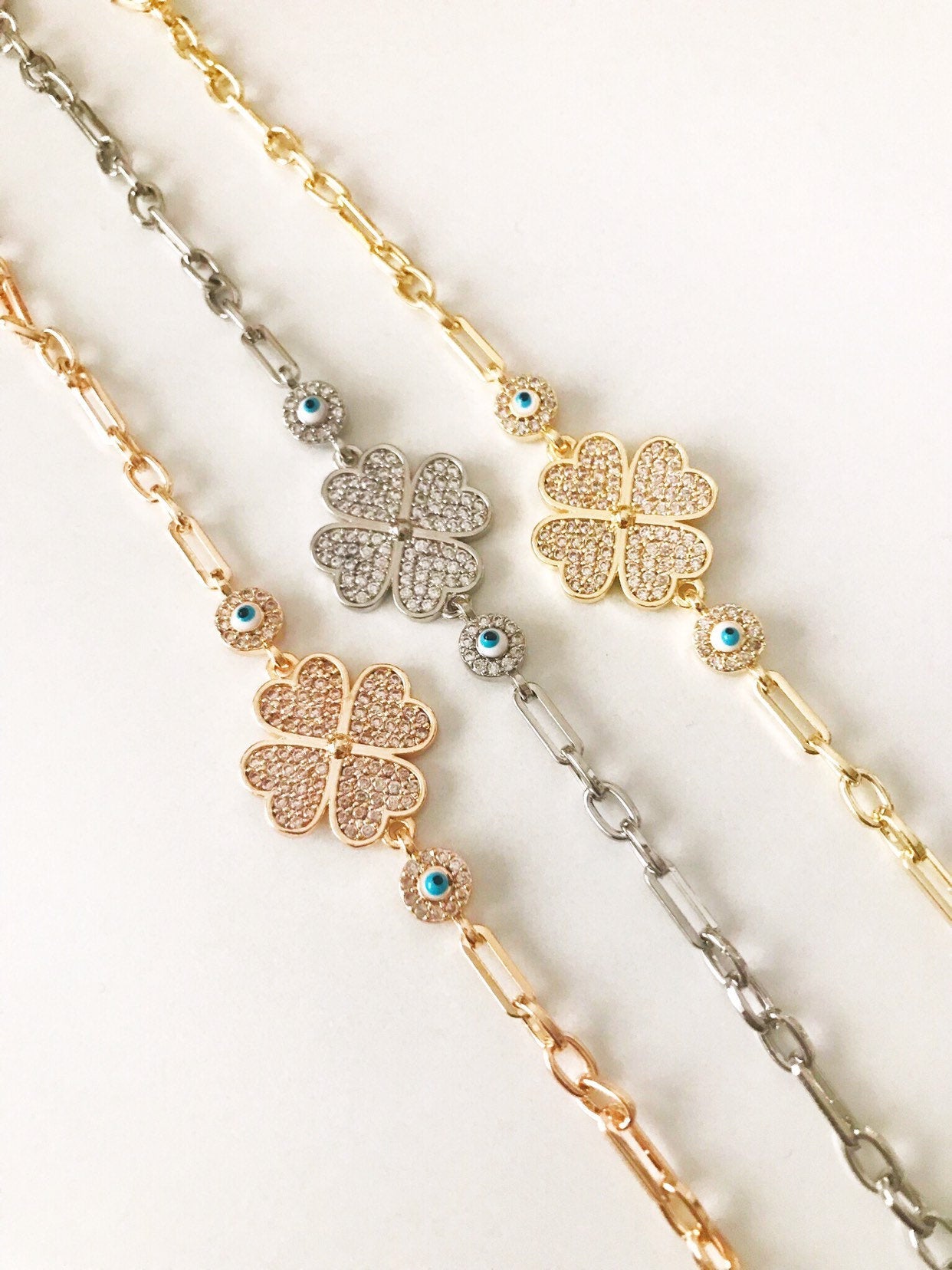 Gold Evil Eye Bracelet Set featuring adjustable bangles with blue evil eye beads, showcasing handmade craftsmanship and tarnish-resistant stainless steel.