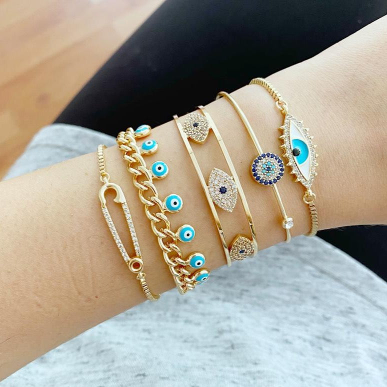 Gold Evil Eye Bracelet Set featuring five unique styles including safety pin and zircon bangle, adorned with blue evil eye beads.