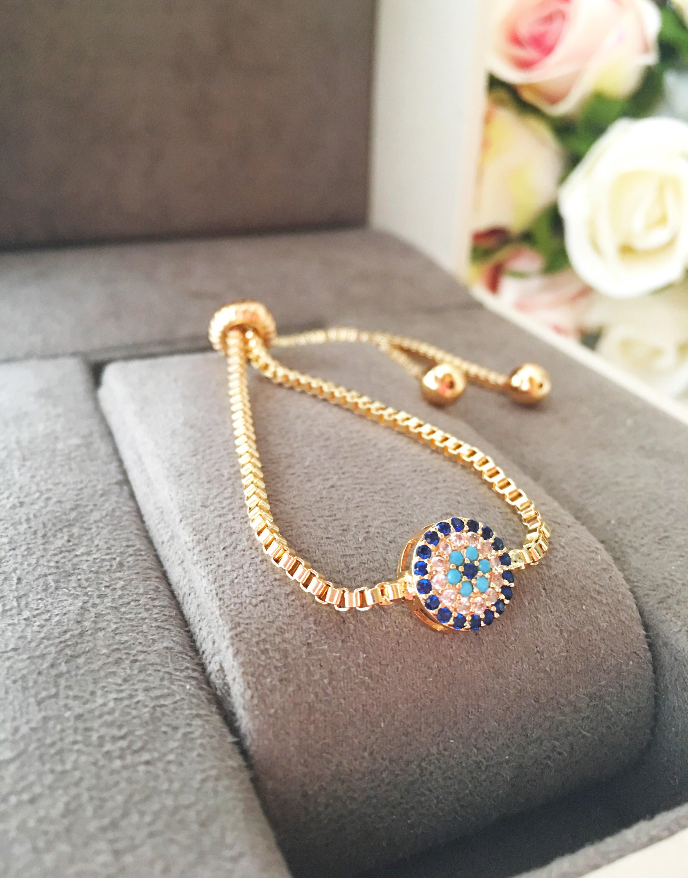 Gold Evil Eye Bracelet featuring a tiny evil eye bead, adjustable design, and made from tarnish-resistant stainless steel.