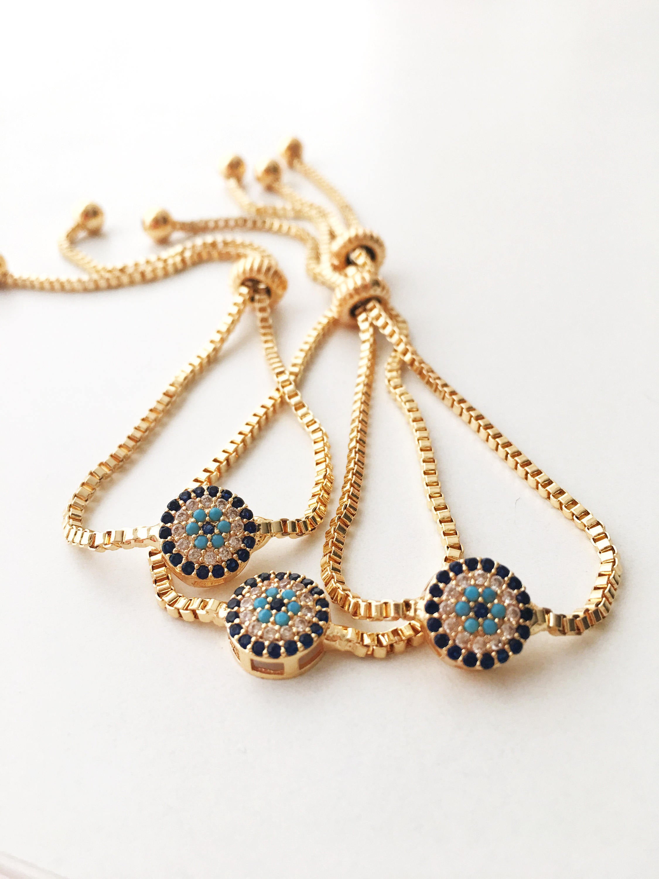 Gold Evil Eye Bracelet featuring a tiny evil eye bead, adjustable design, and made from tarnish-resistant stainless steel.