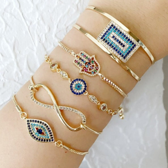 Gold Evil Eye Bracelet featuring a movable oval charm and cuff chain design, perfect for stylish protection.