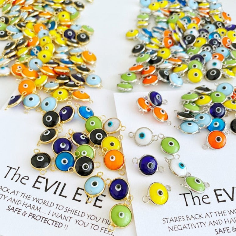 A collection of 25 gold and silver glass evil eye charms, each 10mm in diameter, perfect for DIY jewelry projects.