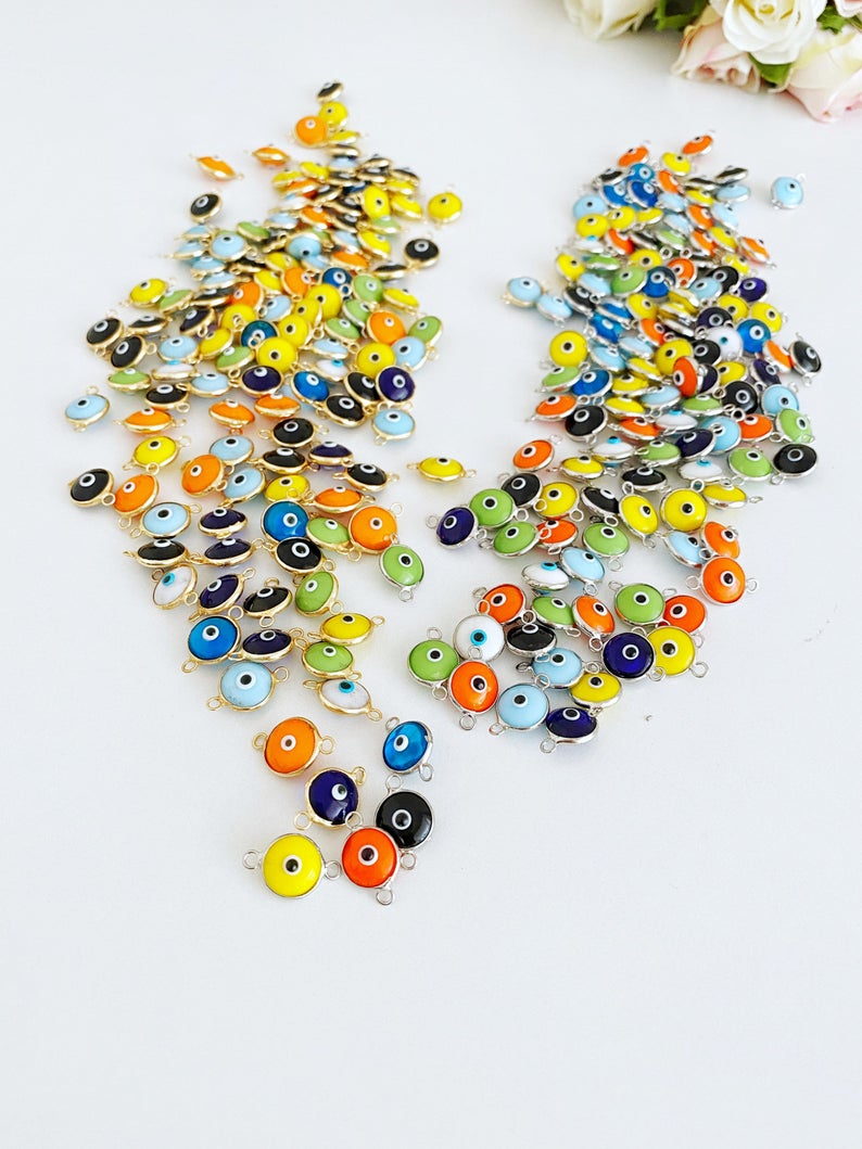 A collection of 25 gold and silver glass evil eye charms, each 10mm in diameter, perfect for DIY jewelry projects.