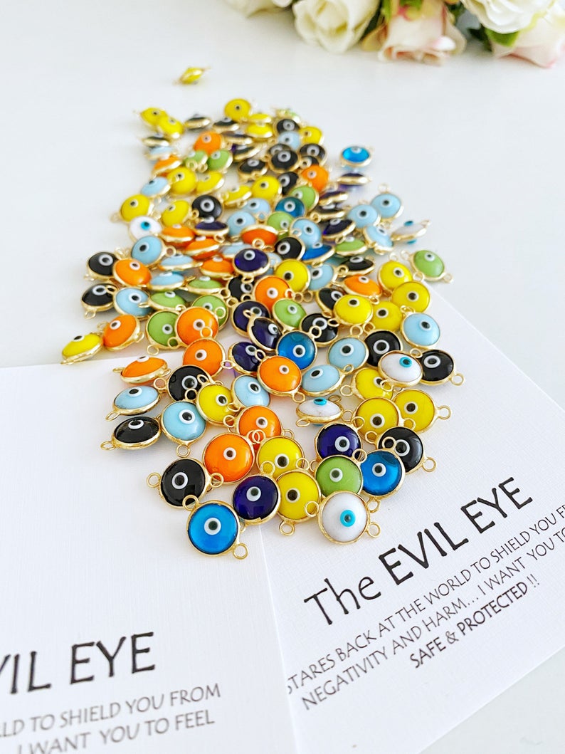 A collection of 25 gold and silver glass evil eye charms, each 10mm in diameter, perfect for DIY jewelry projects.