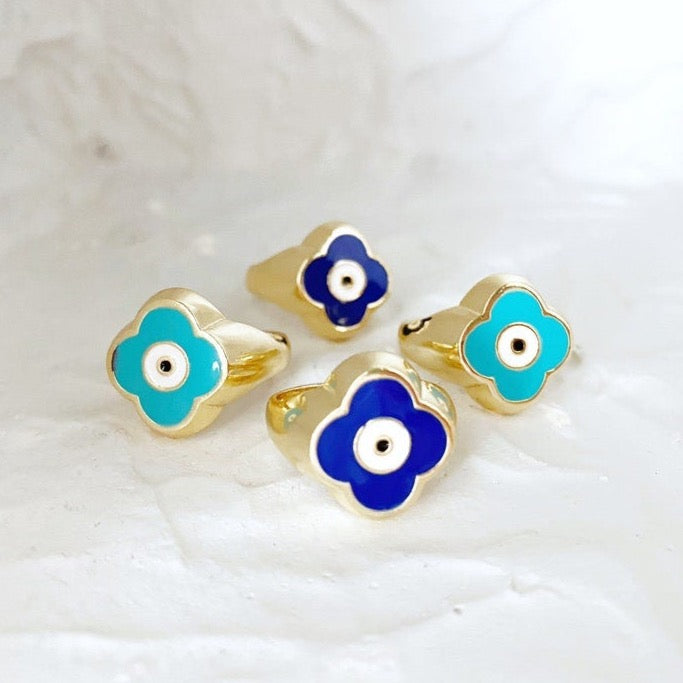 Gold Evil Eye Ring featuring an adjustable band and a four-leaf clover charm in navy blue and turquoise colors.