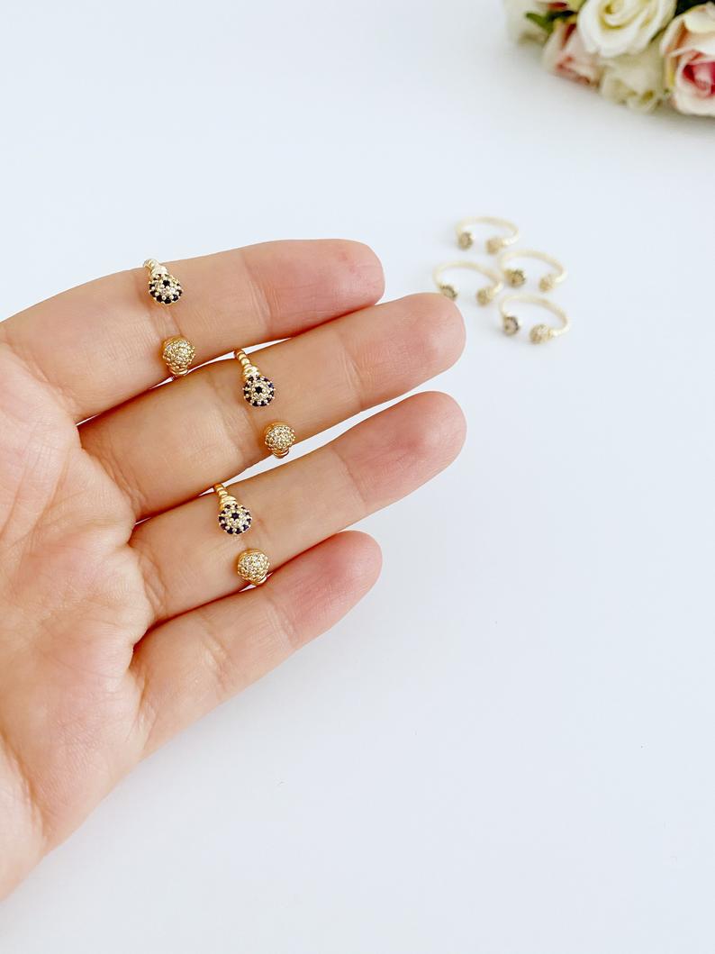 A beautiful Gold Evil Eye Ring featuring a 6mm zircon evil eye bead, adjustable design for all sizes, perfect for stacking or wearing alone.