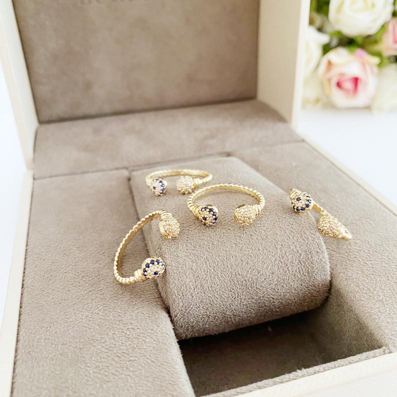 A beautiful Gold Evil Eye Ring featuring a 6mm zircon evil eye bead, adjustable design for all sizes, perfect for stacking or wearing alone.