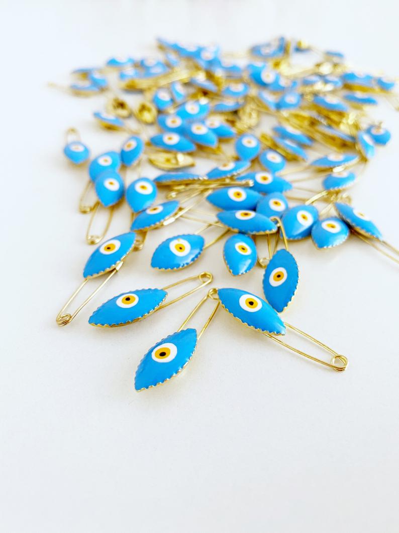Gold Evil Eye Safety Pin featuring a blue evil eye charm, perfect for weddings and baby showers.