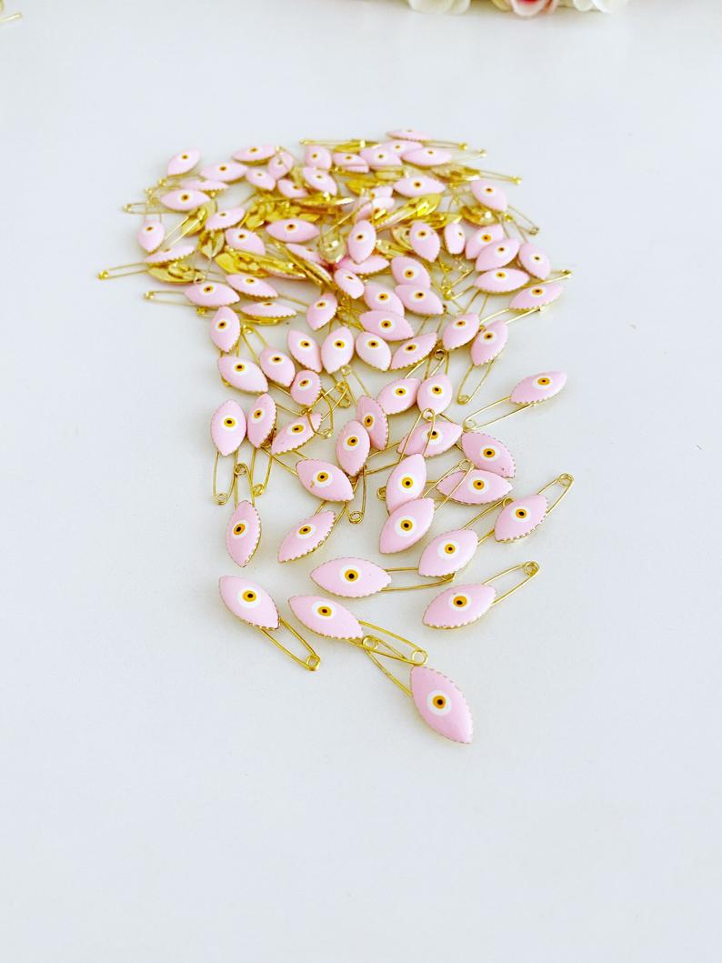 Gold Evil Eye Safety Pin featuring a blue evil eye charm, perfect for weddings and baby showers.