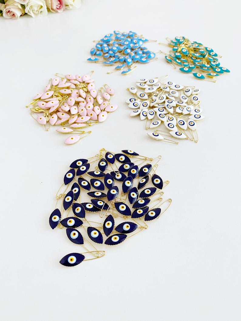 Gold Evil Eye Safety Pin featuring a blue evil eye charm, perfect for weddings and baby showers.