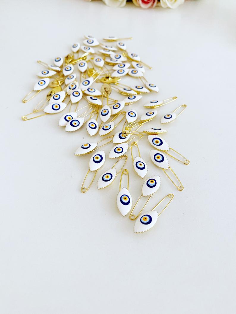 Gold Evil Eye Safety Pin featuring a blue evil eye charm, perfect for weddings and baby showers.