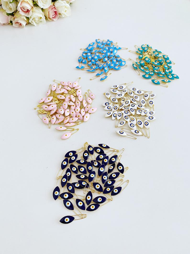 Gold Evil Eye Safety Pin featuring a blue evil eye charm, perfect for weddings and baby showers.