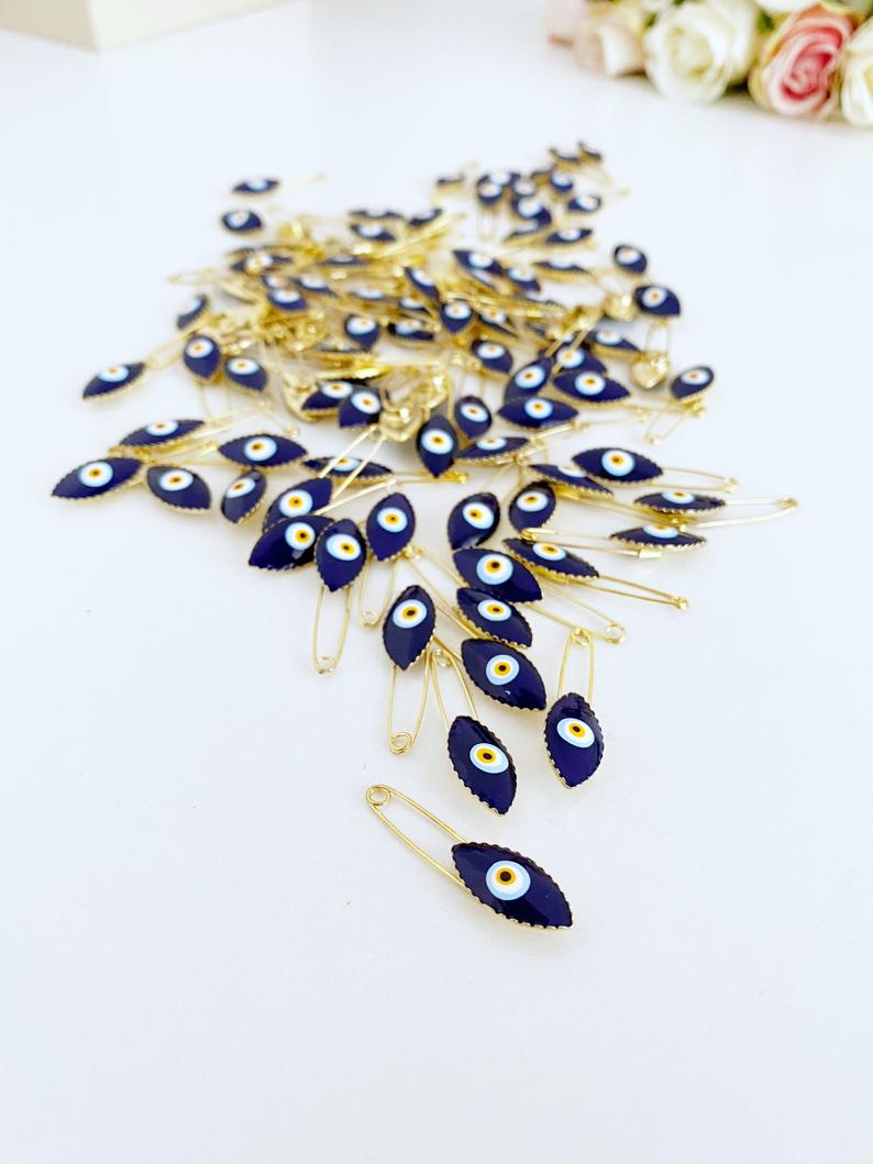 Gold Evil Eye Safety Pin featuring a blue evil eye charm, perfect for weddings and baby showers.