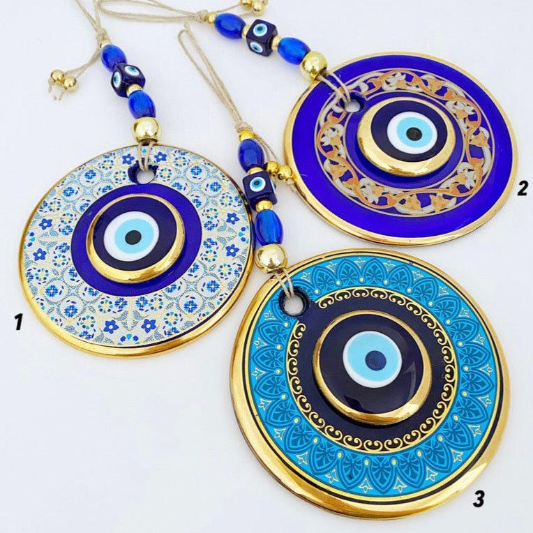A beautiful Gold Evil Eye Wall Hanging featuring intricate designs, large and small evil eye motifs, perfect for home decor and protection.