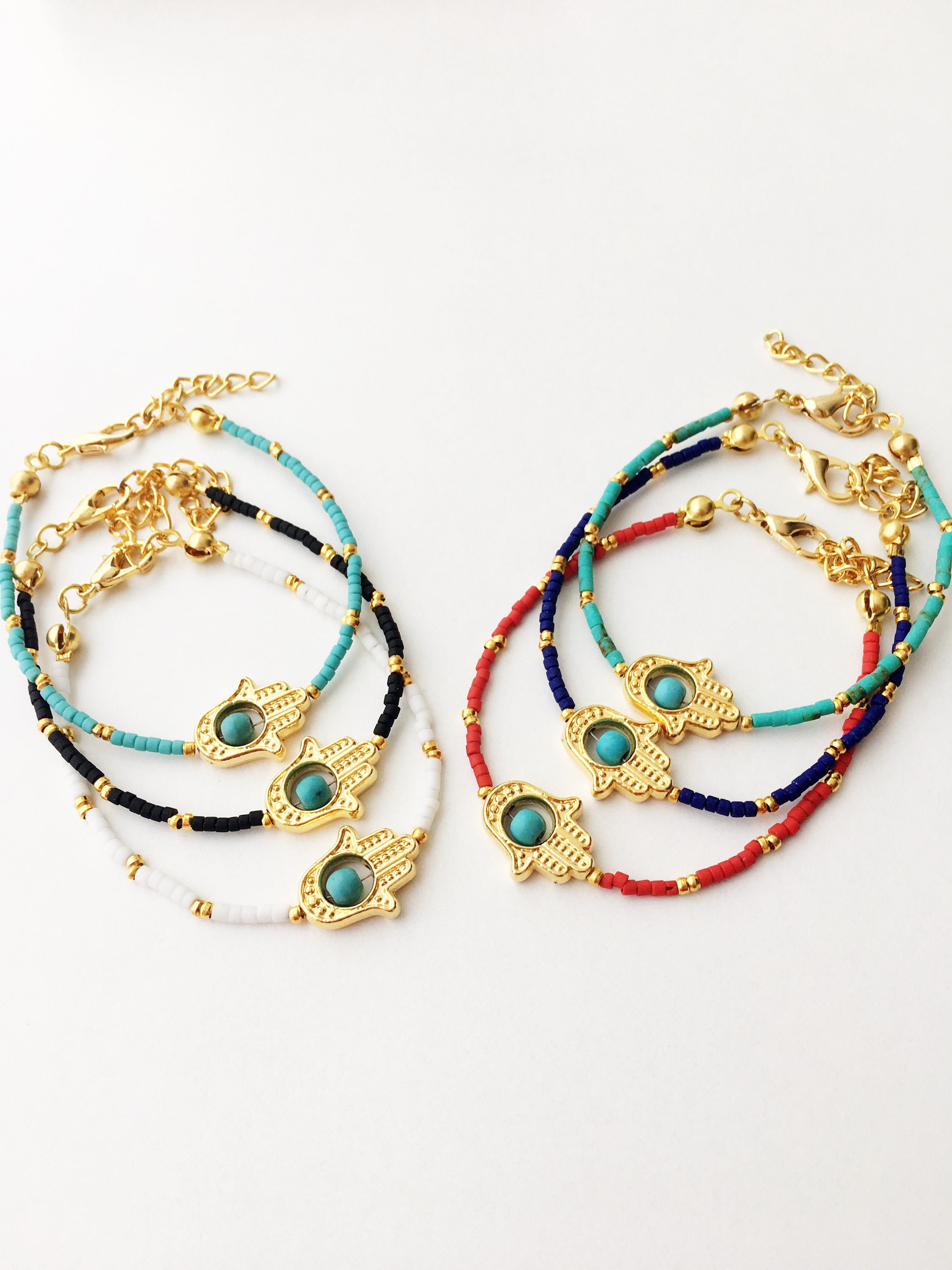 Gold Hamsa Hand Bracelet featuring colorful seed beads and a turquoise bead design, symbolizing luck and protection.