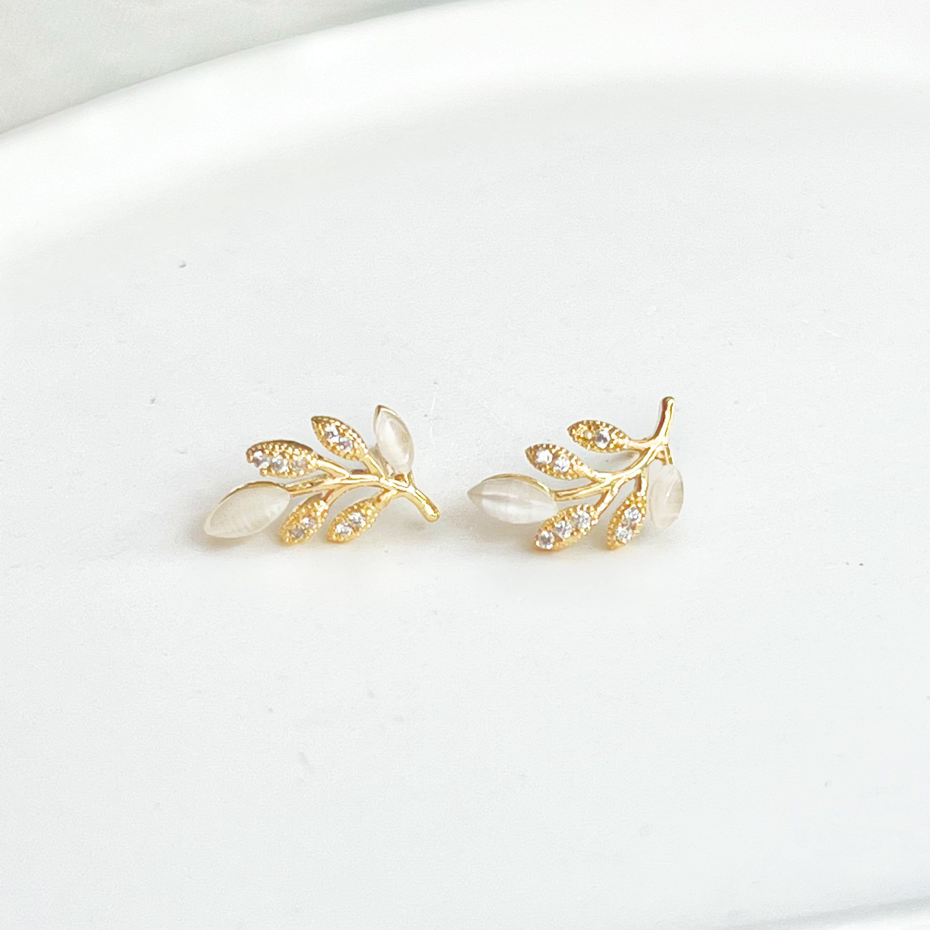 Gold Leaf Stud Earrings featuring Cat Eye Stone and zircon, elegantly designed with a nature-inspired leaf motif.