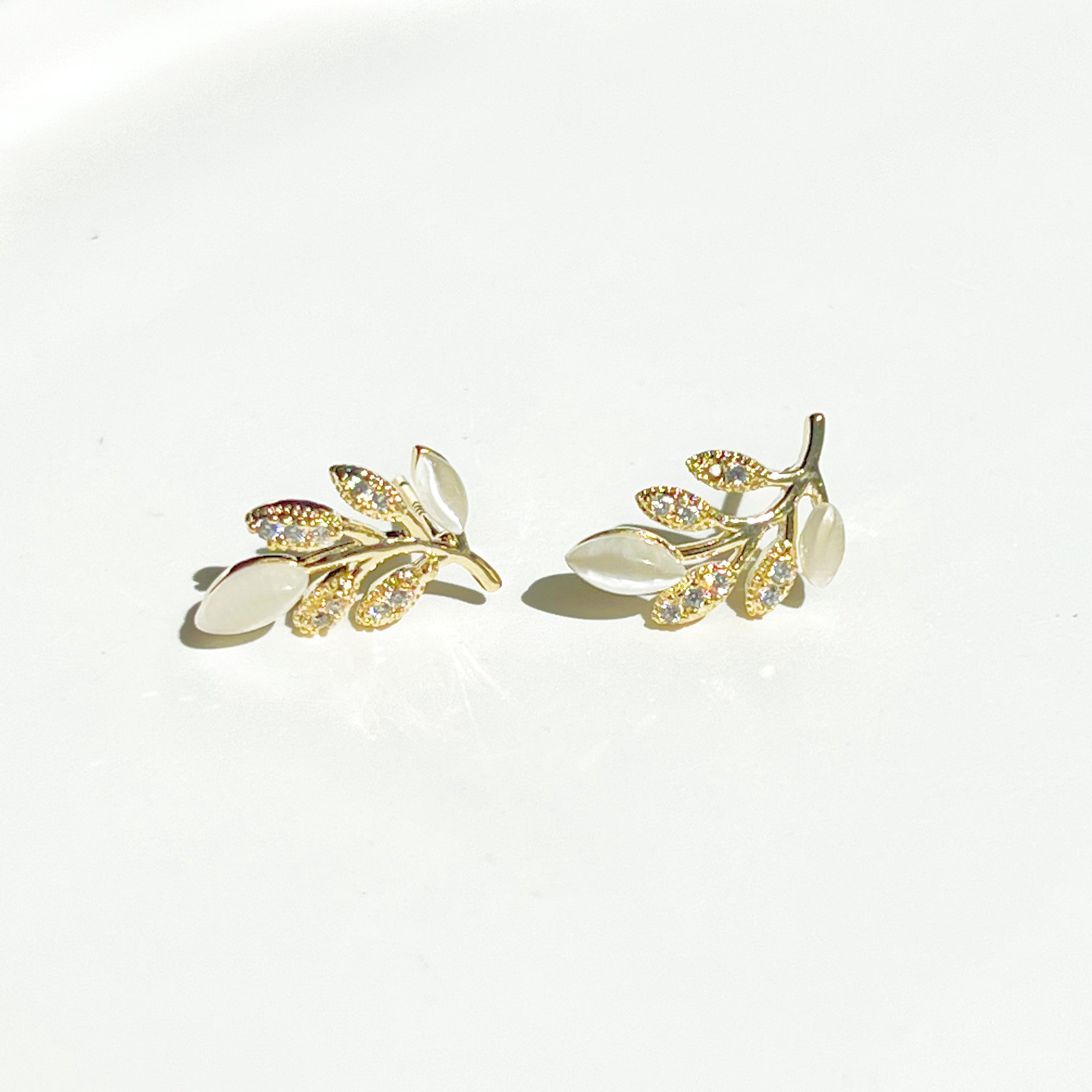 Gold Leaf Stud Earrings featuring Cat Eye Stone and zircon, elegantly designed with a nature-inspired leaf motif.