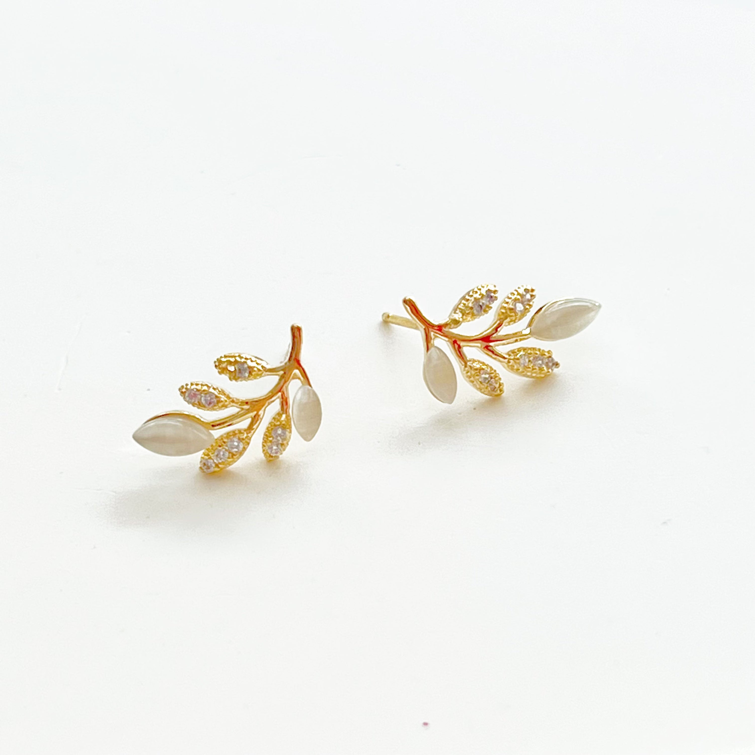 Gold Leaf Stud Earrings featuring Cat Eye Stone and zircon, elegantly designed with a nature-inspired leaf motif.