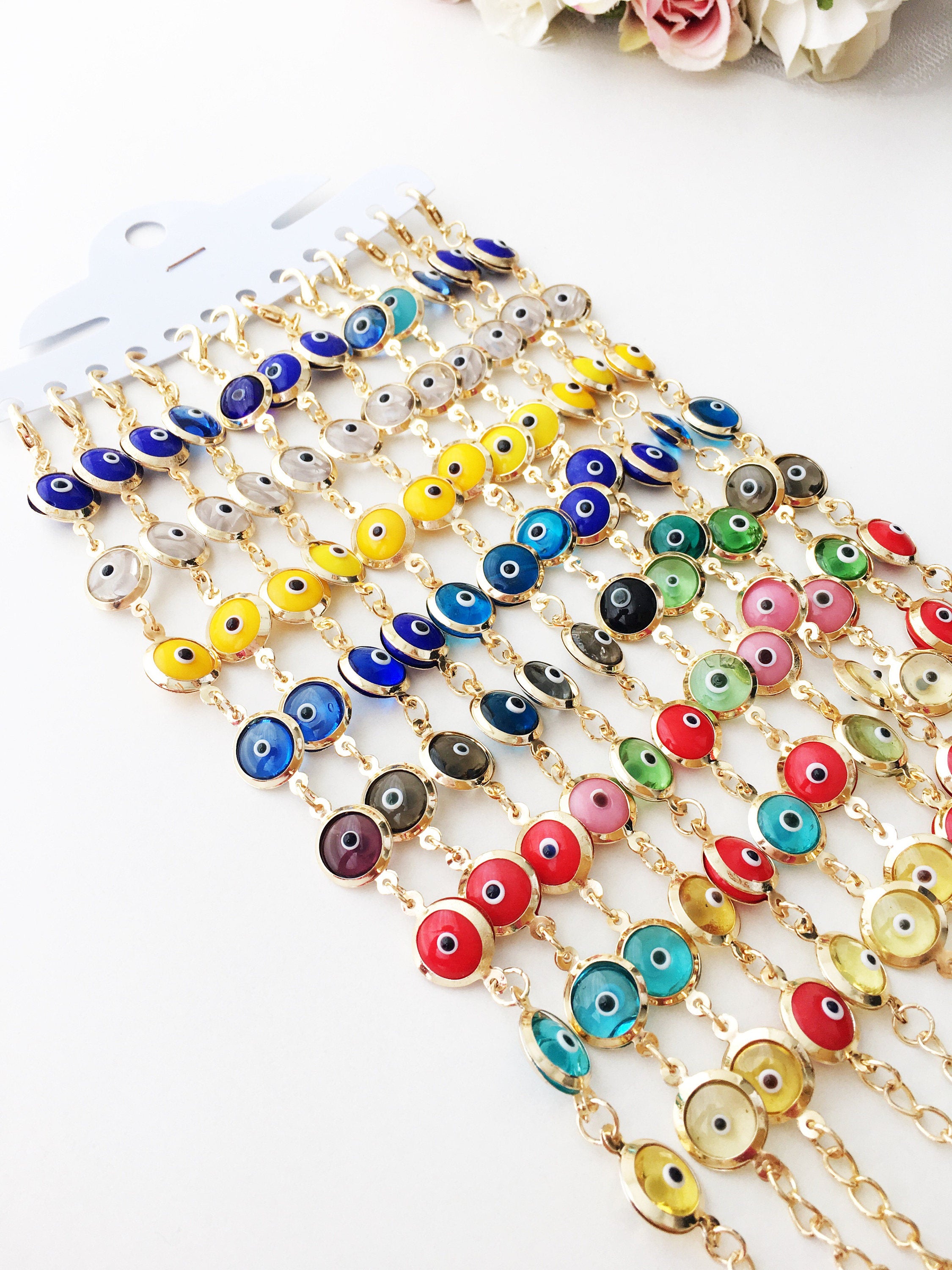 A colorful Gold Link Chain Bracelet featuring rainbow evil eye beads and a stainless steel chain, showcasing vibrant 12mm glass beads.