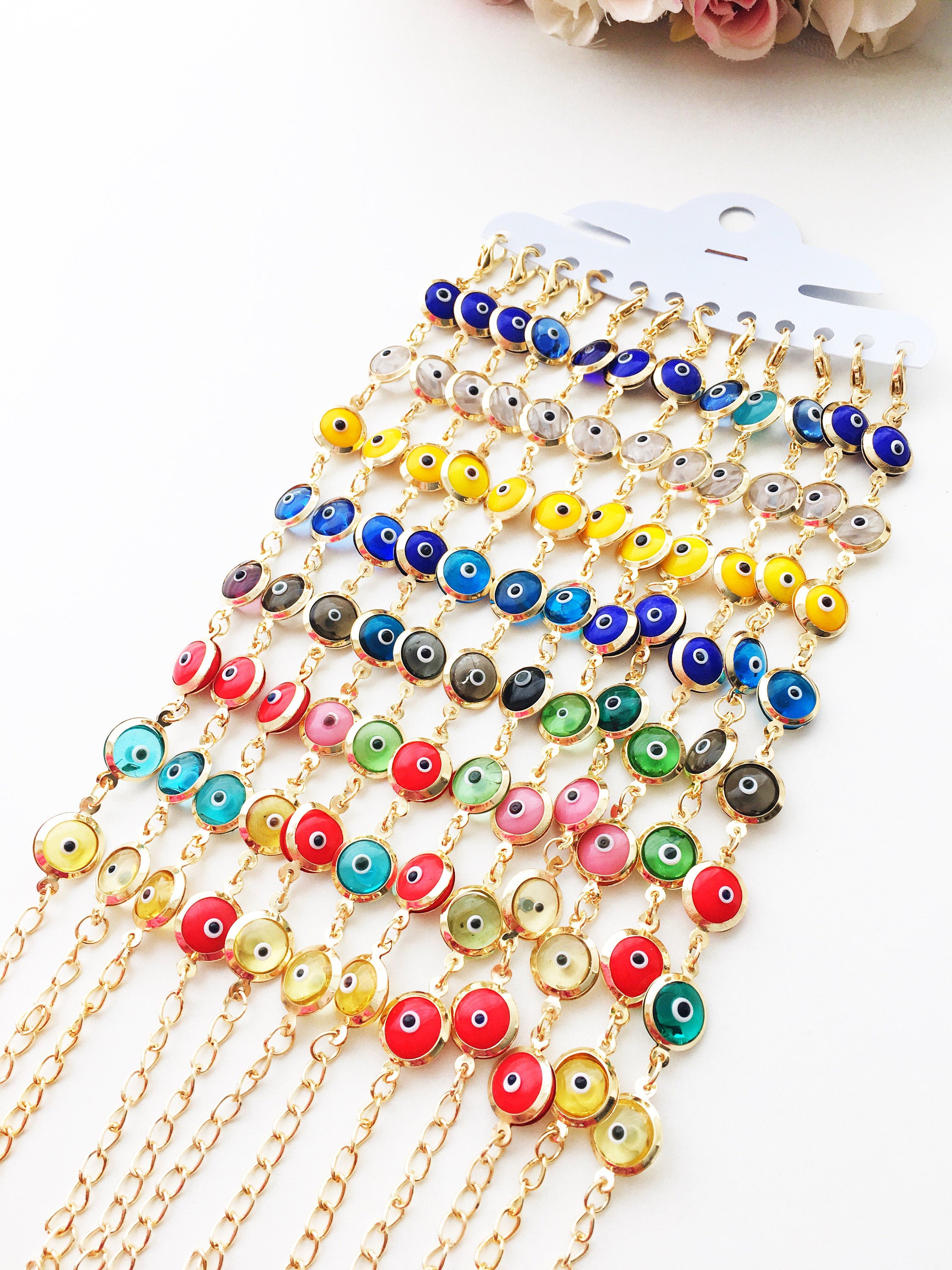 A colorful Gold Link Chain Bracelet featuring rainbow evil eye beads and a stainless steel chain, showcasing vibrant 12mm glass beads.