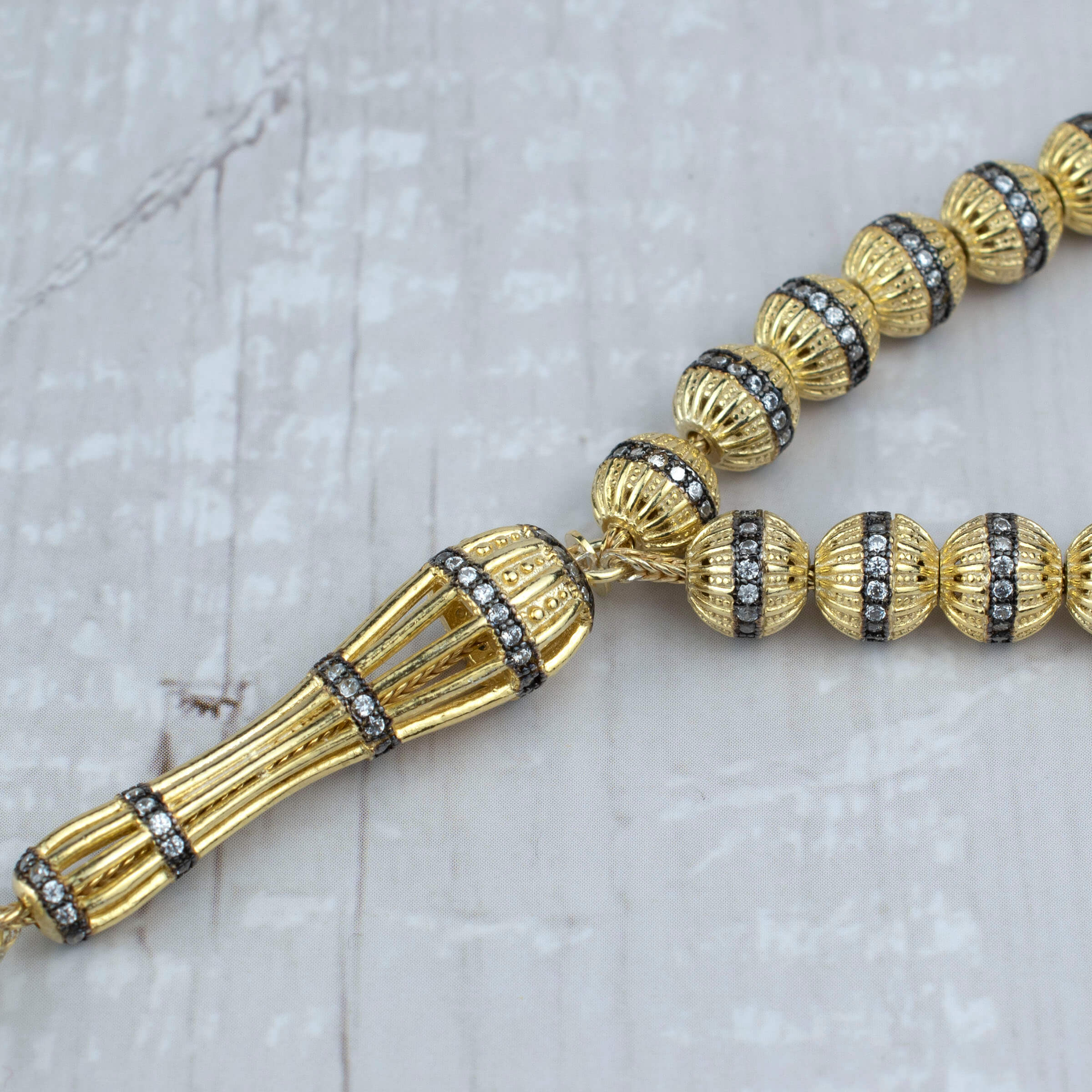 Gold Plated Sterling Silver Tasbih with 33 Zirconia beads, elegantly designed for prayer and meditation.