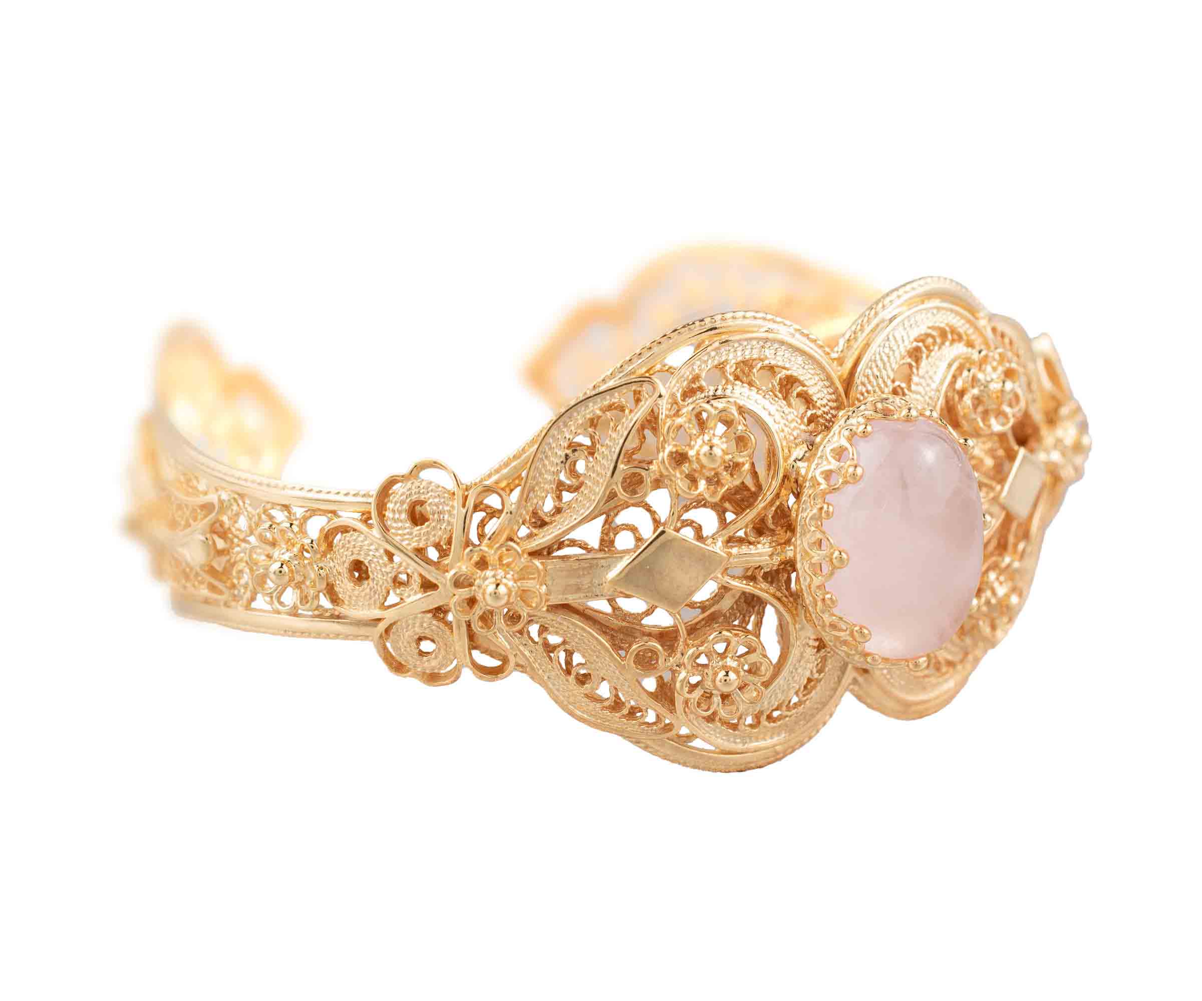 Elegant gold plated sterling silver cuff bracelet featuring intricate filigree art and a beautiful rose quartz gemstone.