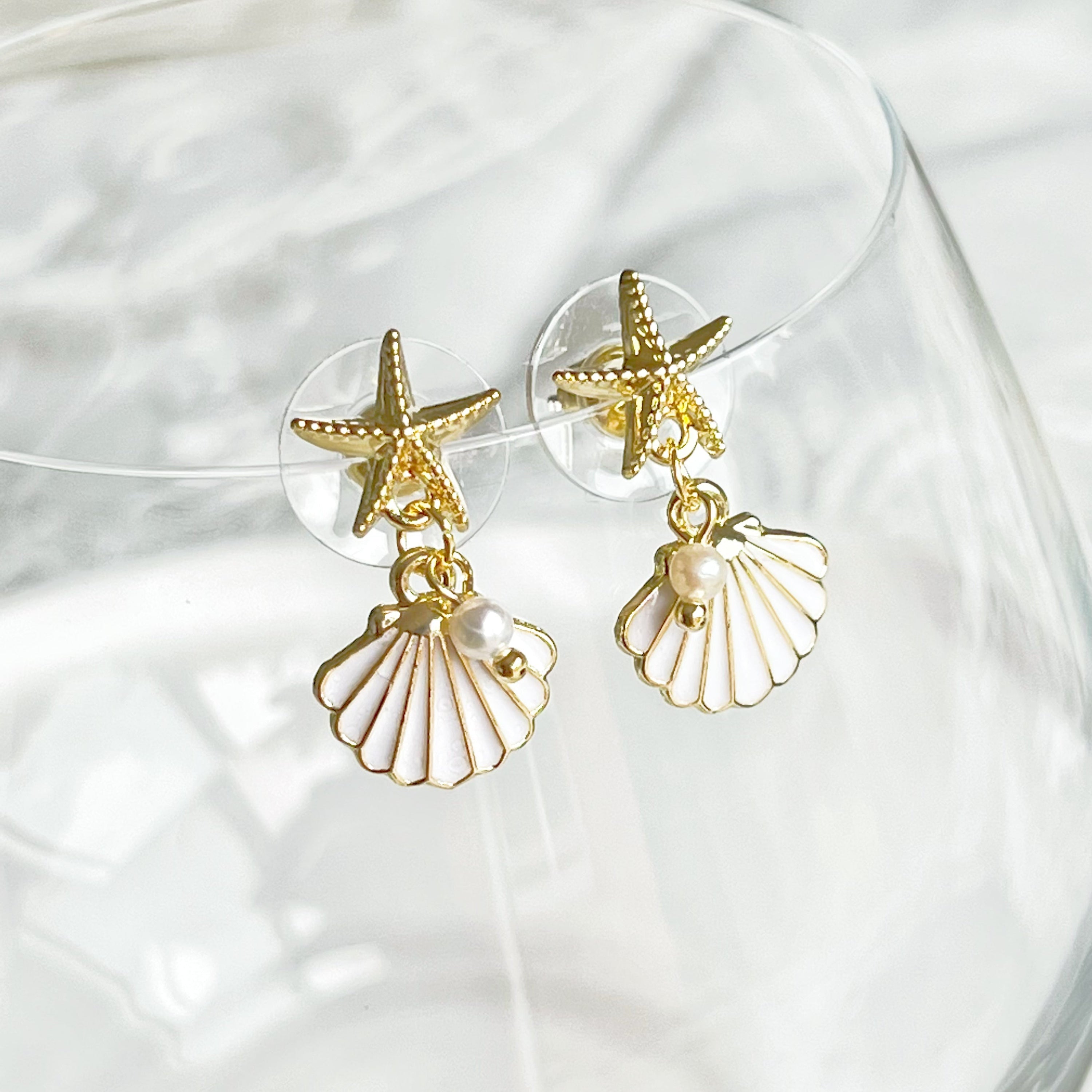 Gold starfish and seashell earrings with mini pearl drop, crafted from gold plated bronze and sterling silver.