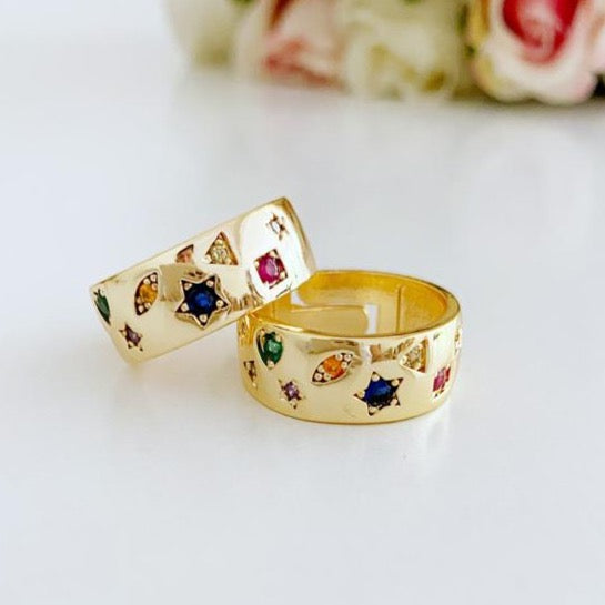 Gold wide band adjustable ring featuring vibrant rainbow zircon stones, perfect for stacking and versatile wear.