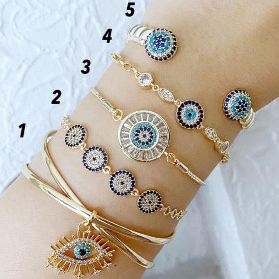 Gold Zircon Cuff Evil Eye Bracelet featuring a zircon charm on a tarnish-resistant stainless steel cuff.