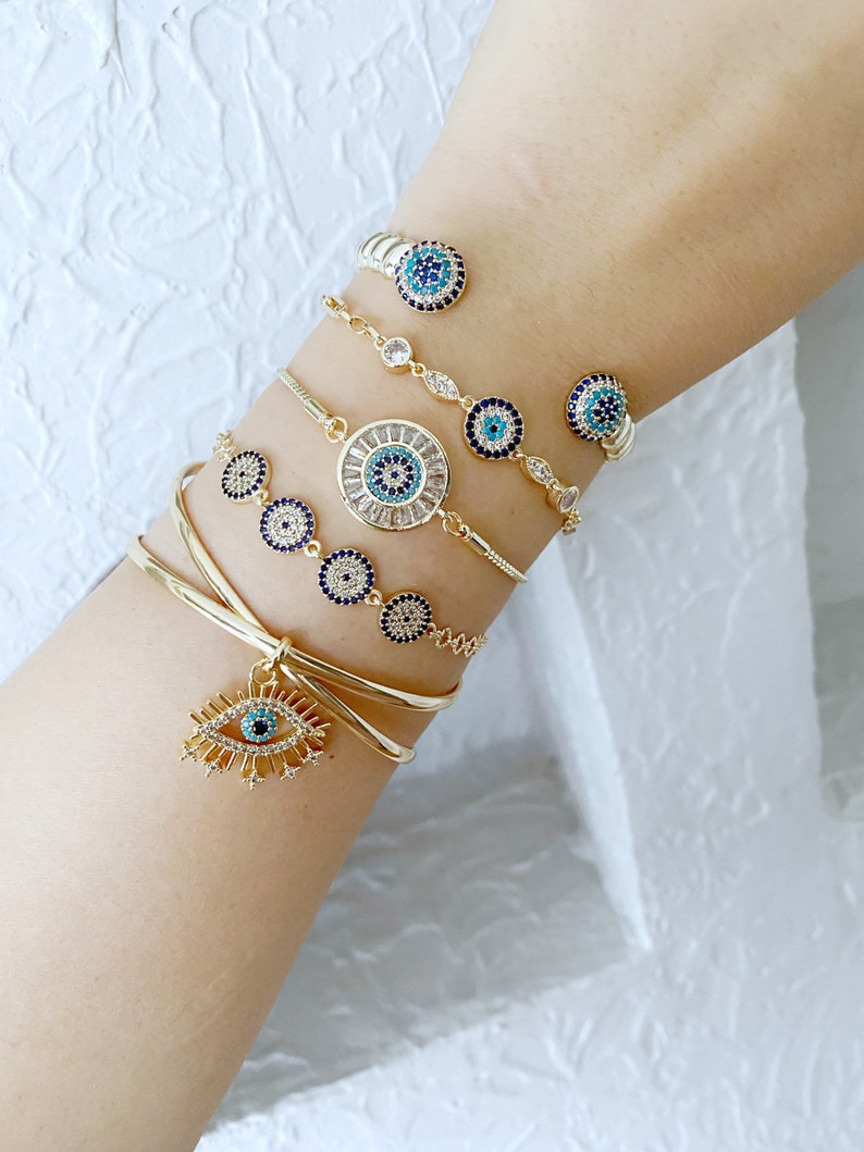 Gold Zircon Cuff Evil Eye Bracelet featuring a zircon charm on a tarnish-resistant stainless steel cuff.