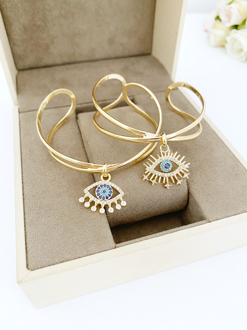 Gold Zircon Cuff Evil Eye Bracelet featuring a zircon charm on a tarnish-resistant stainless steel cuff.