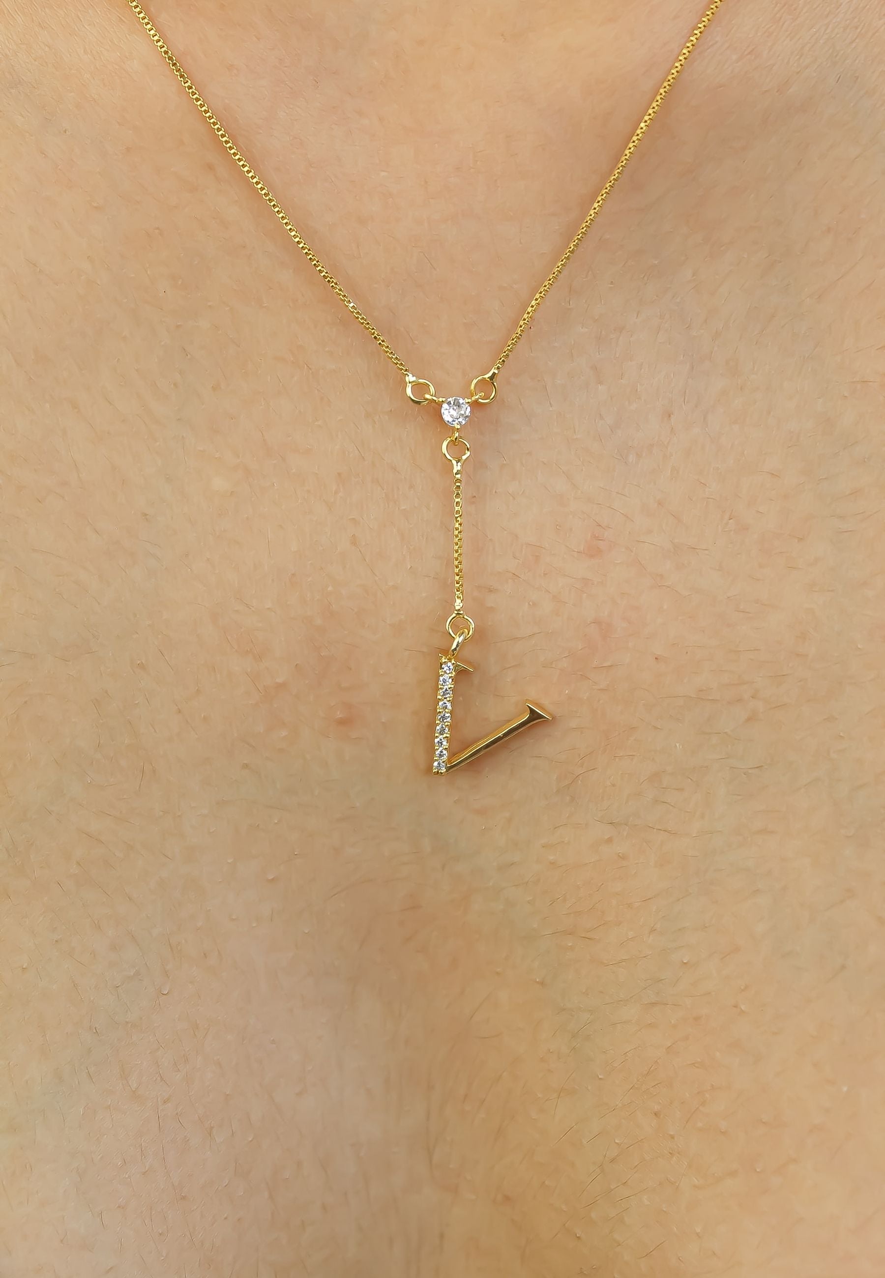 Elegant Golden Alphabet Necklace with zirconia stones, showcasing a personalized initial, perfect for layering or gifting.