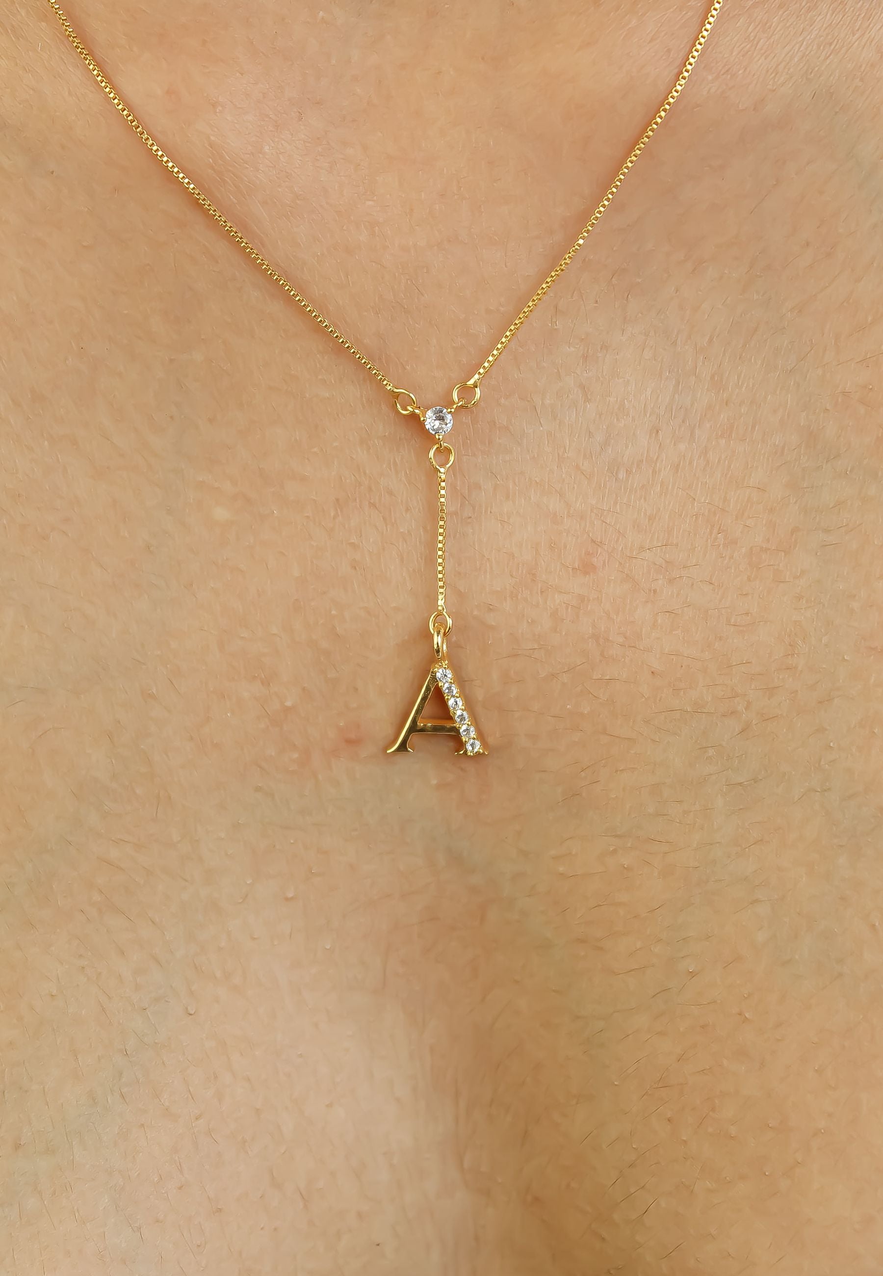 Elegant Golden Alphabet Necklace with zirconia stones, showcasing a personalized initial, perfect for layering or gifting.