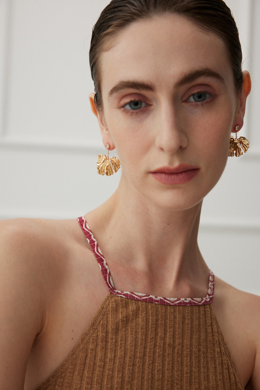 Golden Grove Silver Zircon Leaf Pendant Earrings featuring intricate leaf design and shimmering zircon stones in vintage gold color.