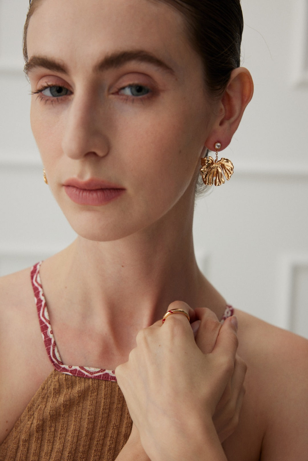 Golden Grove Silver Zircon Leaf Pendant Earrings featuring intricate leaf design and shimmering zircon stones in vintage gold color.