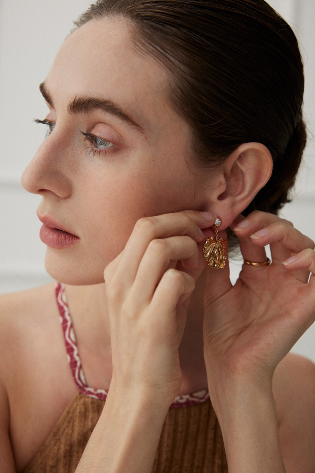 Golden Grove Silver Zircon Leaf Pendant Earrings featuring intricate leaf design and shimmering zircon stones in vintage gold color.