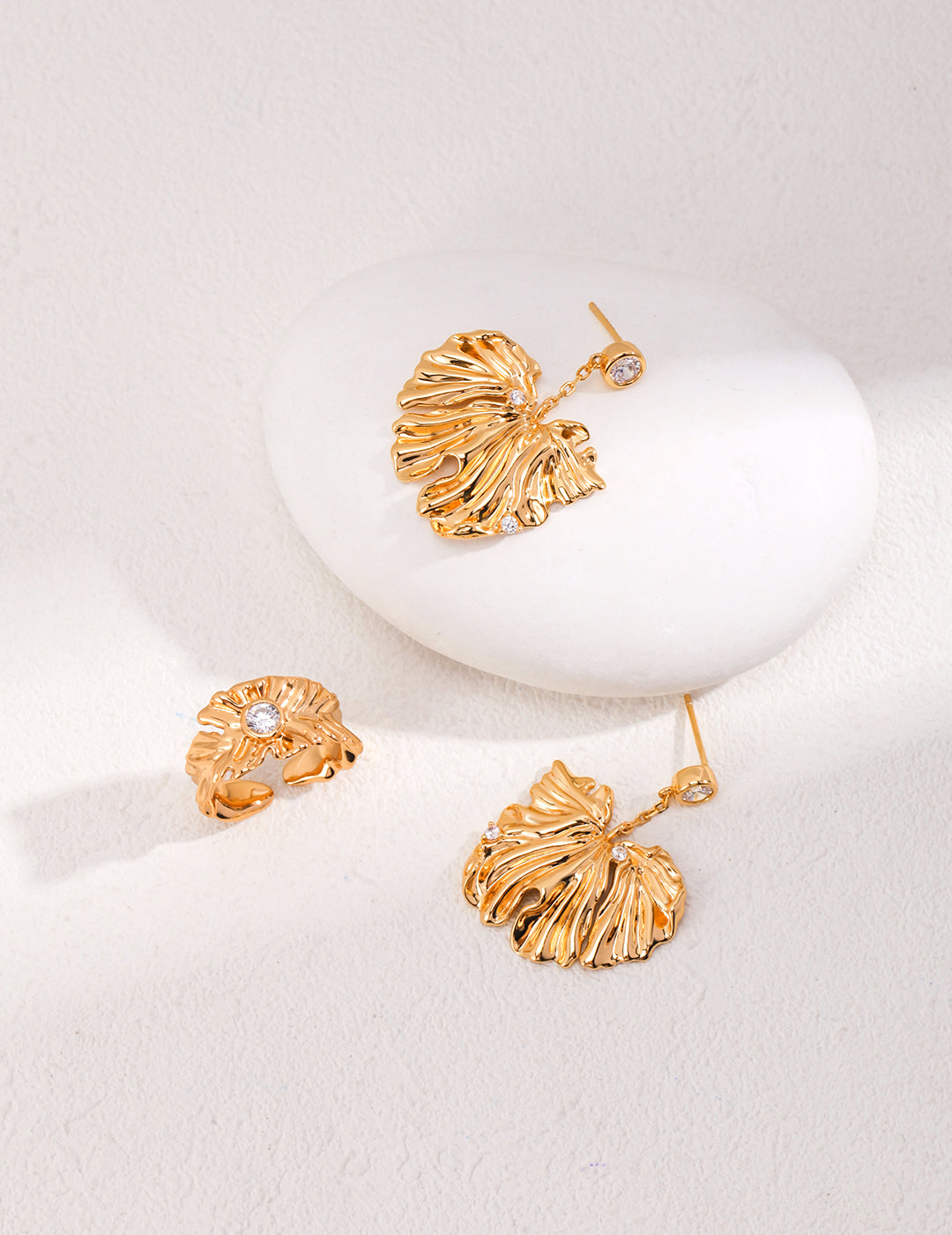 Golden Grove Silver Zircon Leaf Pendant Earrings featuring intricate leaf design and shimmering zircon stones in vintage gold color.