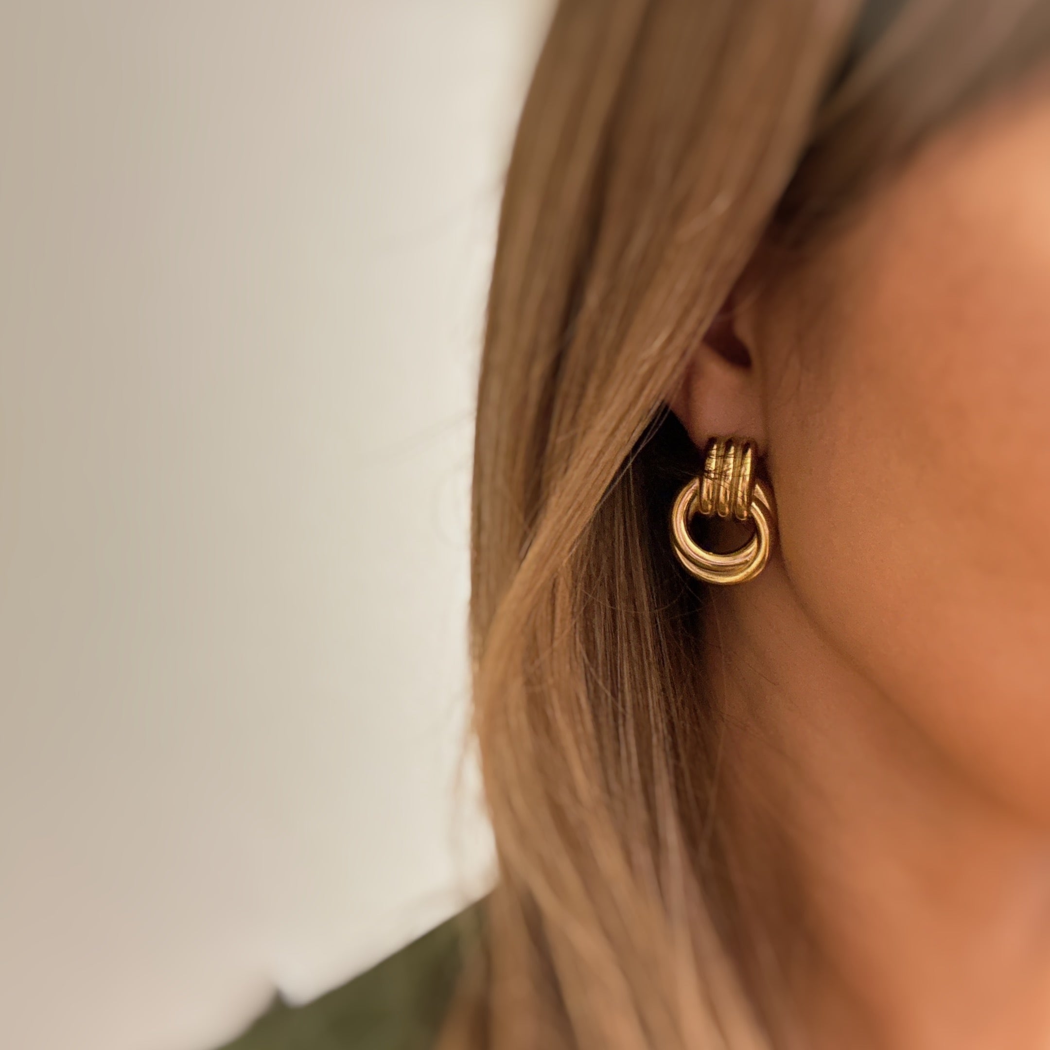 Elegant Golden Knocker Earrings featuring a modern knot design, crafted from 18k gold plated stainless steel.