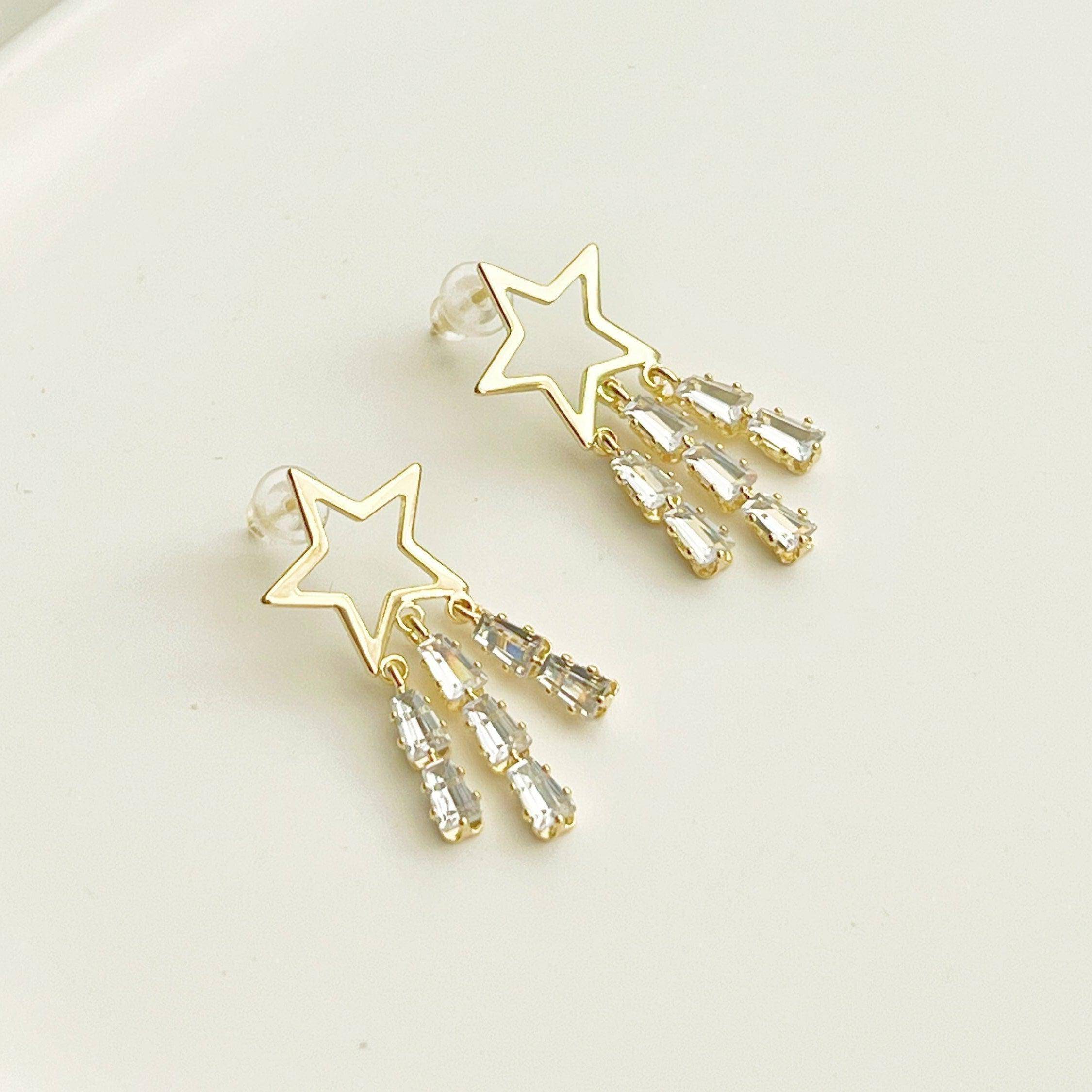 Golden Shooting Stars Earrings featuring three crystal tails, crafted from gold plated bronze and sterling silver, elegantly designed for a sparkling look.