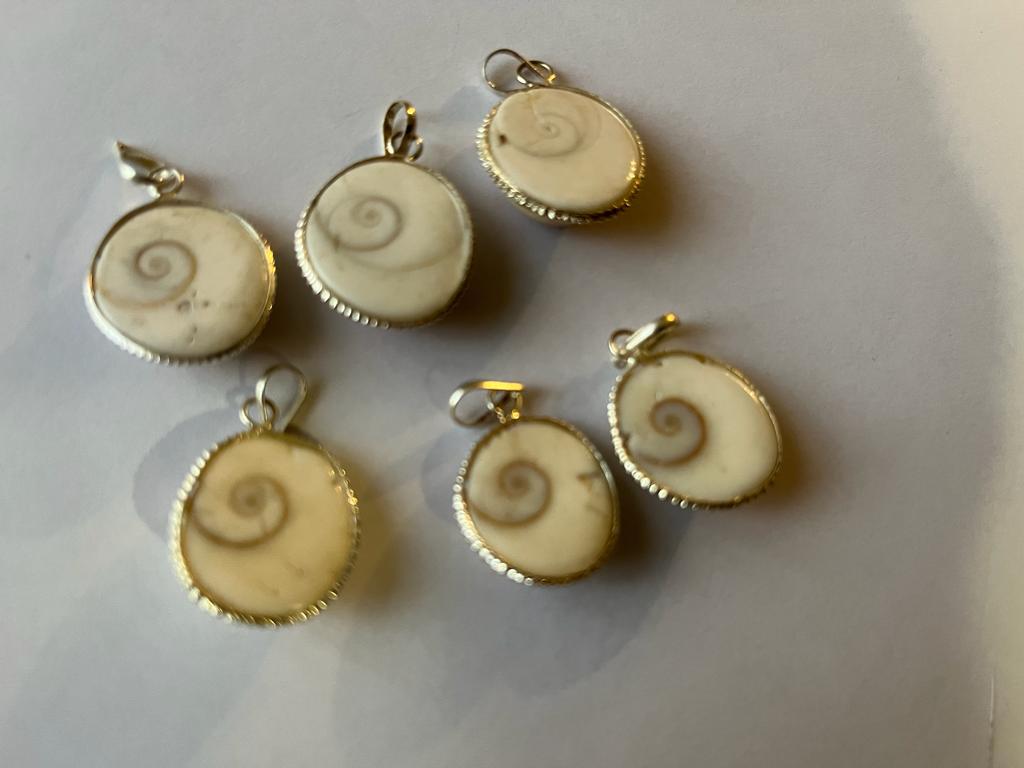 Gomti Chakra Pendant showcasing a natural shell stone with intricate designs, symbolizing protection and spirituality.
