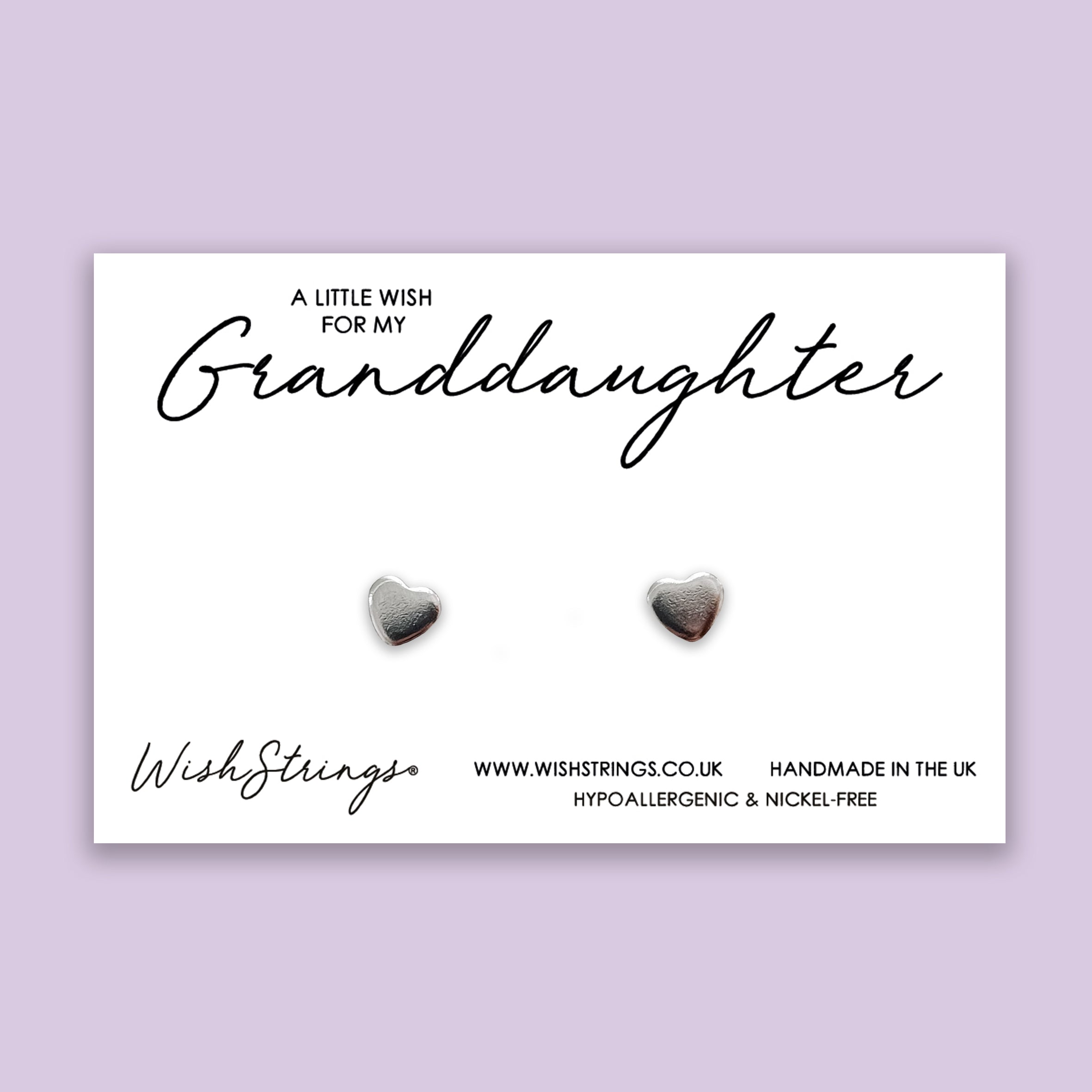 A pair of elegant silver heart stud earrings made from hypoallergenic 304 stainless steel, displayed on a gift card.