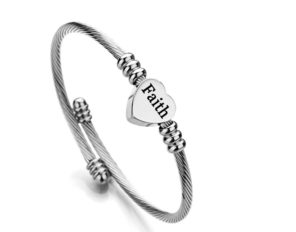 A high polished 'Faith' stainless steel charm bangle featuring a heart initial charm and a heart quote charm, elegantly designed for comfort and style.