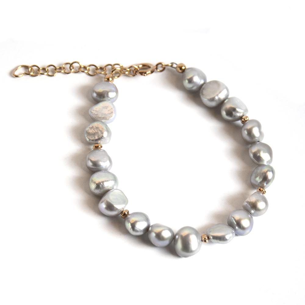A stylish gray freshwater pearl bracelet with gold bead accents, showcasing elegant pearls and a secure gold-plated brass closure.