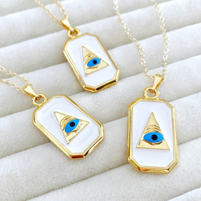 Grecee Evil Eye Necklace featuring a white enamel pendant on a gold chain, symbolizing protection and style.