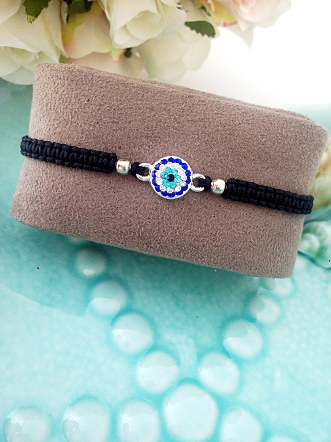 Handmade Greek Evil Eye Bracelet featuring a black macrame design and an evil eye charm, adjustable for all wrist sizes.