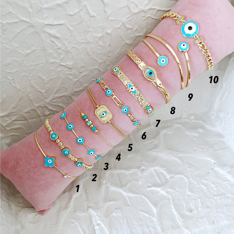 A beautiful Greek Evil Eye Bracelet featuring a blue evil eye charm on a delicate 14K gold chain, perfect for protection and style.