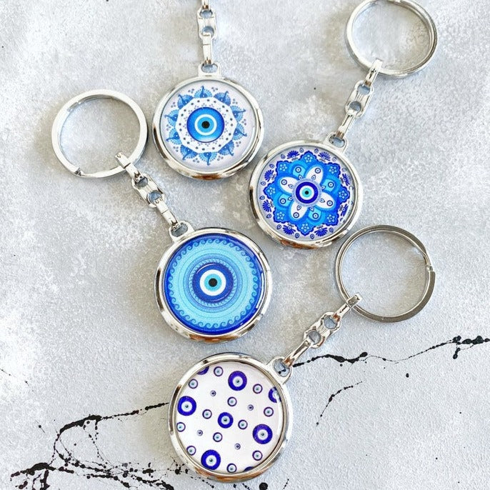 A beautiful Greek Evil Eye Key Chain featuring a blue enamel design, symbolizing protection and good luck, attached to a silver keyring.