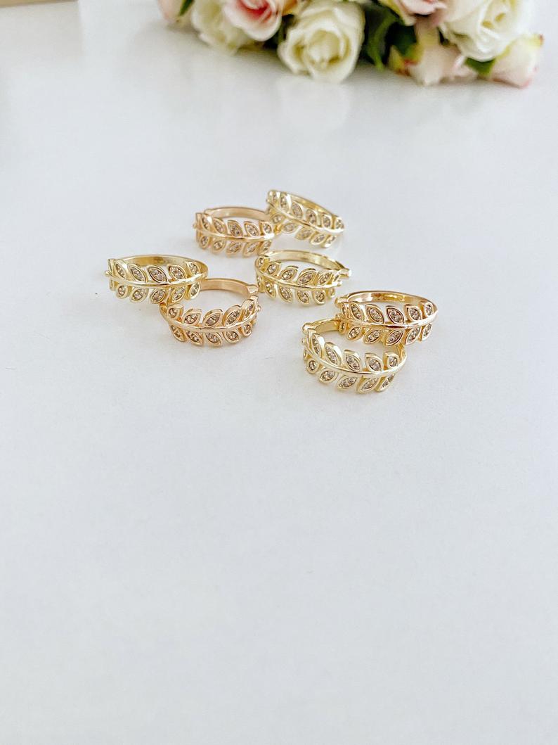 A beautiful gold adjustable Greek Leaf Ring featuring intricate zircon leaves, symbolizing elegance and nature-inspired design.